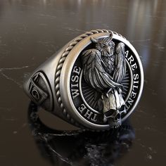 Introducing our 925 Sterling Silver Signet, an extraordinary blend of rich symbolism, intricate artistry, and timeless elegance. Nestled within this ornate design lies the stoic owl skull, an emblem of wisdom, interwoven seamlessly with Masonic Square & Compass symbols representing moral virtue and spiritual insight. Every facet of this signet has been meticulously crafted to showcase the contrast between the enigmatic owl skull and the geometric precision of Masonic icons. The detailing, from t Owl Skull, Compass Symbol, Masonic Ring, Ornate Design, Men Jewelry, Skull Design, Compass, Ring Designs, Statement Rings