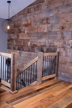 two wooden banisters in front of a wall made out of wood planks