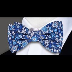 Blooms of Elegance: The Shades of Blue and White Floral Silk Bow Tie A Garden of Style Blooms in Every Knot In the world of men's fashion, a bow tie is not just an accessory; it's an emblem of style and individuality. Our Shades of Blue and White Floral Silk Bow Tie transcends traditional boundaries, offering a garden of intricate flowers that tell a story of elegance and sophistication. In this blog post, we immerse ourselves in the details of this silk masterpiece, exploring styling options, p Blue Bow Tie With Butterfly Knot For Formal Events, Classic Blue Tie With Butterfly Knot, Blue Bow Ties For Black Tie Occasions, Classic Blue Bow Tie With Butterfly Knot, Classic Blue Bow With Butterfly Knot, Blue Bow Ties For Business, Blue Bow Tie For Business, Vintage Blue Ties For Formal Occasions, Vintage Blue Tie For Formal Occasions