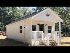 a small white building with stairs leading up to it