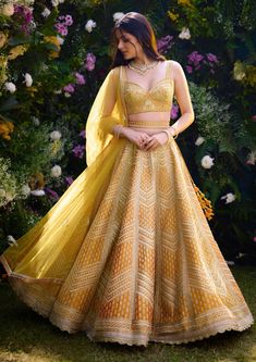 Elevate your style with this apricot yellow raw silk zari dori embroidered lehenga set, a stunning ensemble that exudes elegance and charm. The intricate zari dori embroidery adds a touch of opulence to the rich raw silk fabric, creating a captivating look. Paired with a complementing net dupatta, this ensemble is perfect for adding a touch of glamour to any special occasion. Haldi Lehenga Design, Yellow Lehenga For Haldi Bride, Yellow Bridal Lehenga, Haldi Look For Bride, Haldi Dresses, Haldi Ideas, Haldi Outfit For Bride, Ghaghra Choli, Indian Bridesmaid Dresses