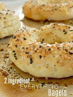 bagels with sesame seeds on them are sitting on a plate and the title reads, 2 ingredient everything bagels