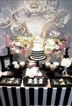 a table topped with a cake and desserts