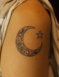 a woman with a crescent and star tattoo on her arm