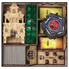 an open box with various items in it, including a clock tower and other accessories