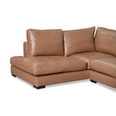 a brown leather sectional sofa with pillows on the armrests and foot rest, in front of a white background