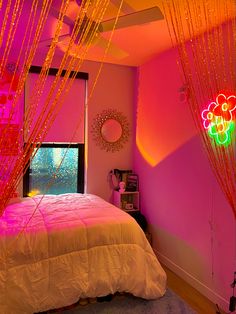 a bedroom with pink walls and neon lights