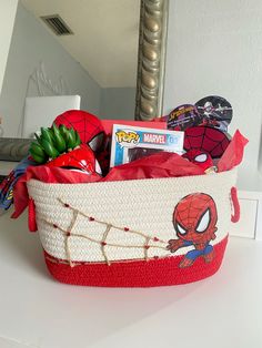 a spiderman themed basket is sitting on the counter