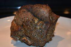 a piece of brownie sitting on top of a white plate