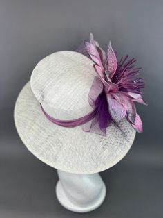 Ivory Oval Hat adorned oversized purple floral bloom. Adorned with netting and the jeweled bee, my signature mark on all of my designer pieces. This piece is adjustable with an internal elastic to fit crown size 22.5" and smaller. Please measure prior to purchasing as all sales are final. Searching for a custom piece? Please contact me via email: TheHatHive@gmail.com for details and pricing. Don’t forget to follow us on Instagram @TheHatHive Flower Shaped Mini Hats For Evening, Elegant Purple Flower Fascinator, Designer Pieces, My Signature, Light Ivory, Purple Floral, Seychelles, Pitcairn Islands, Guinea Bissau