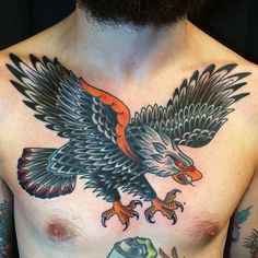 a bald man with tattoos on his chest has an eagle tattoo on it's chest