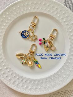 three charms on a plate with the words pick your charms