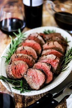 beef tenderies with red wine sauce on a white plate