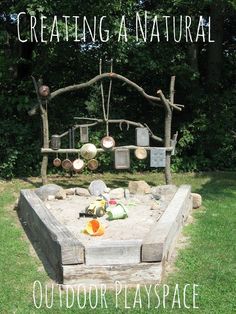 an outdoor sandbox with pots and pans on it