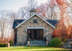 a stone house with steps leading up to the front door