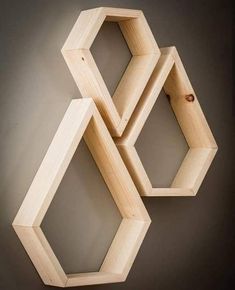 three wooden hexagonal shelves on the wall