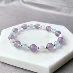 Crystal Protection Bracelet | Amethyst, Aquamarine, Moonstone Gemstone Bracelet | High-Grade Gem Stone, Beaded Bracelet, Dainty Bracelet, Gift For Her ✧ DETAILS - This Bracelet is made with powerful crystals for protection, natural 5-6mm High-Grade Aquamarine AA Moonstone. It is strung on non-fray, latex-free, stretch cording, and the knot is fused and hidden. Your Bracelet will be made with positive intentions, cleansed, and charged prior to packaging. - Lavender Amethyst - Emotional Balance & Soothing - Aquamarine - Purifying & Cleansing - Moonstone - New beginnings & positive outlook - 925 Sterling Silver ✧ UNIQUE - All of the stones and crystals I use in my bracelets are natural and hand-picked. The Earth is constantly changing and so do the crystals and gemstones that grow within it. Crystals For Protection, Wire Beading, Crystal Protection, Powerful Crystals, Lavender Amethyst, Personal Energy, Sterling Silver Bead Bracelet, Energy Bracelets, Bracelet Dainty