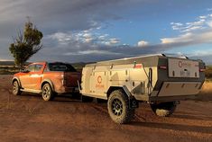 an off - road vehicle with a camper trailer attached to it's back