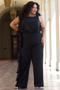 Sydney's Closet CE2014 Trendy plus size formal jumpsuit looks elegant at any special occasion whether you're a guest at a wedding, spending a night on the town or having brunch with family and friends. One-piece silhouette in rich French crepe fabric makes dressing up effortless. Asymmetrical flounce on bodice and pant creates a sleek, sophisticated look that elongates and shapes your body. Keyhole back adds modern design detail. Lined in stretch knit for extra comfort. Wear this versatile, slee Wedding Pants Outfit Guest, Wedding Pants Outfit, Plus Size Formal Jumpsuit, Jumpsuit Outfit Wedding, Jumpsuit One Shoulder, Plus Size Pant Suits, Plus Size Dressy, Dressy Jumpsuits, Jumpsuit Plus Size