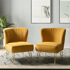 two yellow chairs sitting next to each other on a rug