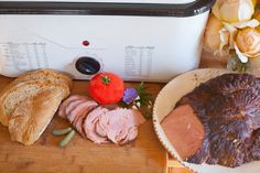 ham, bread and tomatoes on a cutting board next to an open toaster oven