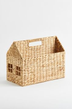 a wicker basket with a house on it