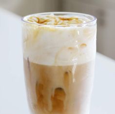 a glass filled with liquid sitting on top of a table