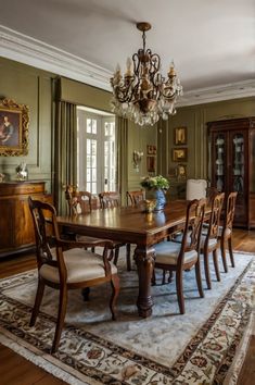 a dining room table with chairs and a chandelier