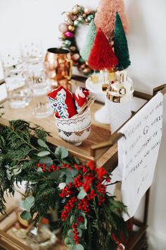 christmas decorations are displayed on the table in front of other holiday items and decor pieces