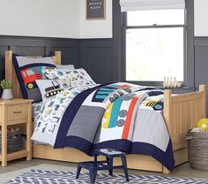 a child's bed with construction themed comforter