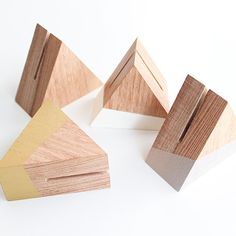 three pieces of wood sitting next to each other on a white surface with one piece missing