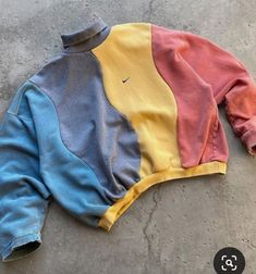 a colorful sweatshirt laying on the ground