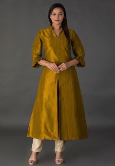 Art Bhagalpuri Silk Kurta in Old Gold. This Readymade Piece with Cotton Lining Attire is Chinese Collar. Neck and Quarter SleevesIts Length is 50 inches. Do Note: Bottom and All accessories shown in image is for presentation purpose only ( Slight variation in actual color vs. image is possible) We sell all kinds of women's and ladies tops Casual Kurtas |Indian Tops |Gowns |Ladies Dresses |Indian Fashionable Tops |Indian topwear |Office wear |Holiday wear |Girls Tops |Teenager tops |Cotton Kurtis A Line Kurti Designs, Collar Kurti Design, Tops Indian, Indo Western Outfits For Women, Collar Kurti, Cotton Suit Designs, Silk Kurti Designs, Indian Tops, A Line Kurti