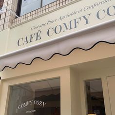 the sign for cafe comfy couty is displayed on the front of the building