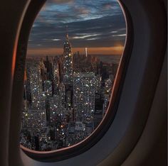 an airplane window looking out at the city