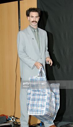 a man in a suit and tie holding a bag