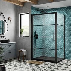 a bathroom with blue and white tiles on the walls, flooring and shower stall