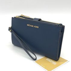 Brand New With Tag Michael Kors Lg Double Zip Wallet Wristlet Color: Navy Saffiano Leather Gold Hardware Interior Features 1 Id Window Pocket, 6 Credit Card Slots, 2 Slip Pockets, 1 Phone Pocket, Bill Compartment And 2 Zipper Compartments Detachable 7"L Leather Wrist Strap Measures Approximately 7.25" (W) X 4.25" (H) X 0.75" (D) Snap Closure Travel Wallets With Gold-tone Hardware, Michael Kors Travel Wallets With Gold-tone Hardware, Michael Kors Travel Wallet Clutch, Micheal Kors Wallet, Mk Wallet, Michael Kors Clutch, Leather Trifold Wallet, Michael Kors Wristlet, Blue Wallet