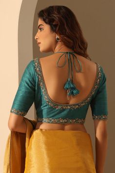 Teal blouse crafted in raw silk base with placement hand embroidery.
Components: 1
Pattern: Hand Embroidery
Type Of Work: Floral
Neckline: V Neck
Sleeve Type: Half Sleeves
Fabric: Raw Silk
Color: Green,Blue
Other Details: 
Model height: 5ft 6inches, wearing size S
Back tie-up detailing with tassels
Note: The saree worn by the model is not for sale
Occasion: Mehendi and Puja - Aza Fashions Dola Silk Blouse For Reception And Transitional Season, Silk Embroidered Fabric For Unstitched Blouse, Reception, Elegant Blouse With Resham Embroidery In Dola Silk, Festive Raw Silk Blouse With Intricate Embroidery, Silk Embroidered Top With Intricate Embroidery, Tissue Silk Blouse With Intricate Embroidery For Receptions, Reception Blouse With Intricate Embroidery In Tissue Silk, Semi-stitched Tissue Silk Blouse For Reception, Tissue Silk Blouse With Zari Work For Reception