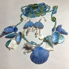 Summer Is Here! These Are Real Seashells That I Hand Painted In The Colors Of The Ocean, Sky And Driftwood. I Added Mother Of Pearl, Freshwater Pearls And Sweet Little Silver Sea Turtles And A Silver Anchor. The Chain Is Made Of Glass Pearls In The Same Beach Colors. The. Necklace Only. Earrings Have Been Sold. Necklace Is Long For Double Wrapping. Ocean-inspired Blue Shell Jewelry, Summer Blue Shell Jewelry, Coastal Blue Beaded Jewelry, Blue Bohemian Shell Jewelry, Bohemian Blue Shell Jewelry, Beach Colors, Beach Necklace, Silver Sea, Ocean Sky