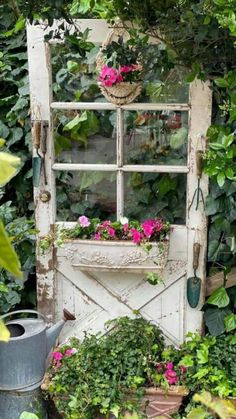 an old door is surrounded by plants and flowers