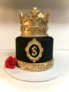 a three tiered black and gold cake with a red rose on the bottom layer