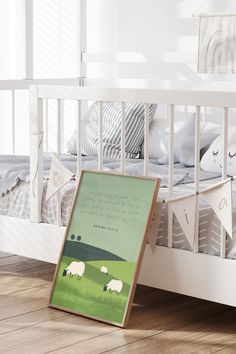 a white crib with a green poster on the bottom and sheep in the background