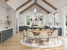 a dining room table surrounded by chairs in a large open concept kitchen with white walls and wooden beams