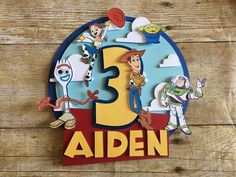 a wooden sign with the number three on it that says,'3 aden '