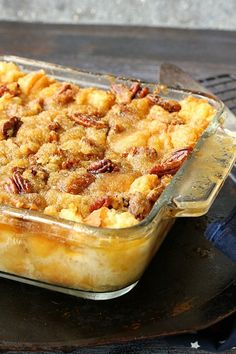 a casserole dish with pecans and other toppings