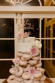 a wedding cake with donuts stacked on top