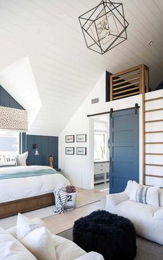 a bedroom with a loft bed, white couches and a ladder in the ceiling