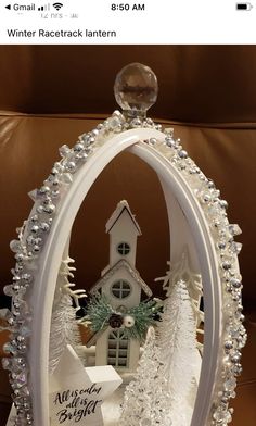 a white christmas decoration with a church in the middle