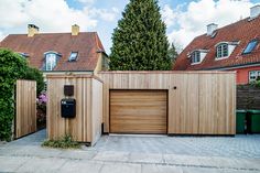 two garages are next to each other in front of some houses